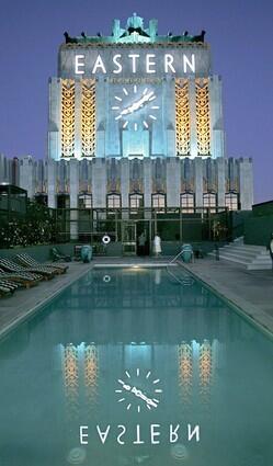 The stunning clock tower of the Eastern Columbia building, lighted at night to showcase its Deco façade, is reflected in the swimming pool. Claude Beelman designed the tower, which caps the Eastern's 13 stories.