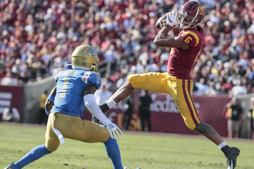 LOS ANGELES, CA, SATURDAY, NOVEMBER 23, 2019 - USC Trojans wide receiver Michael Pittman Jr. catches a pass in front of UCLA Bruins defensive back Darnay Holmes (1) at the Coliseum. (Robert Gauthier/Los Angeles Times)
