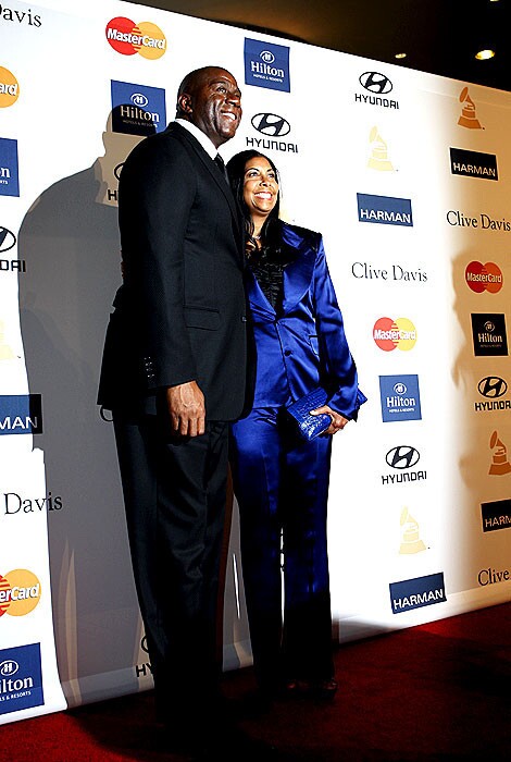 Magic Johnson with wife Cookie pose on the red carpet.