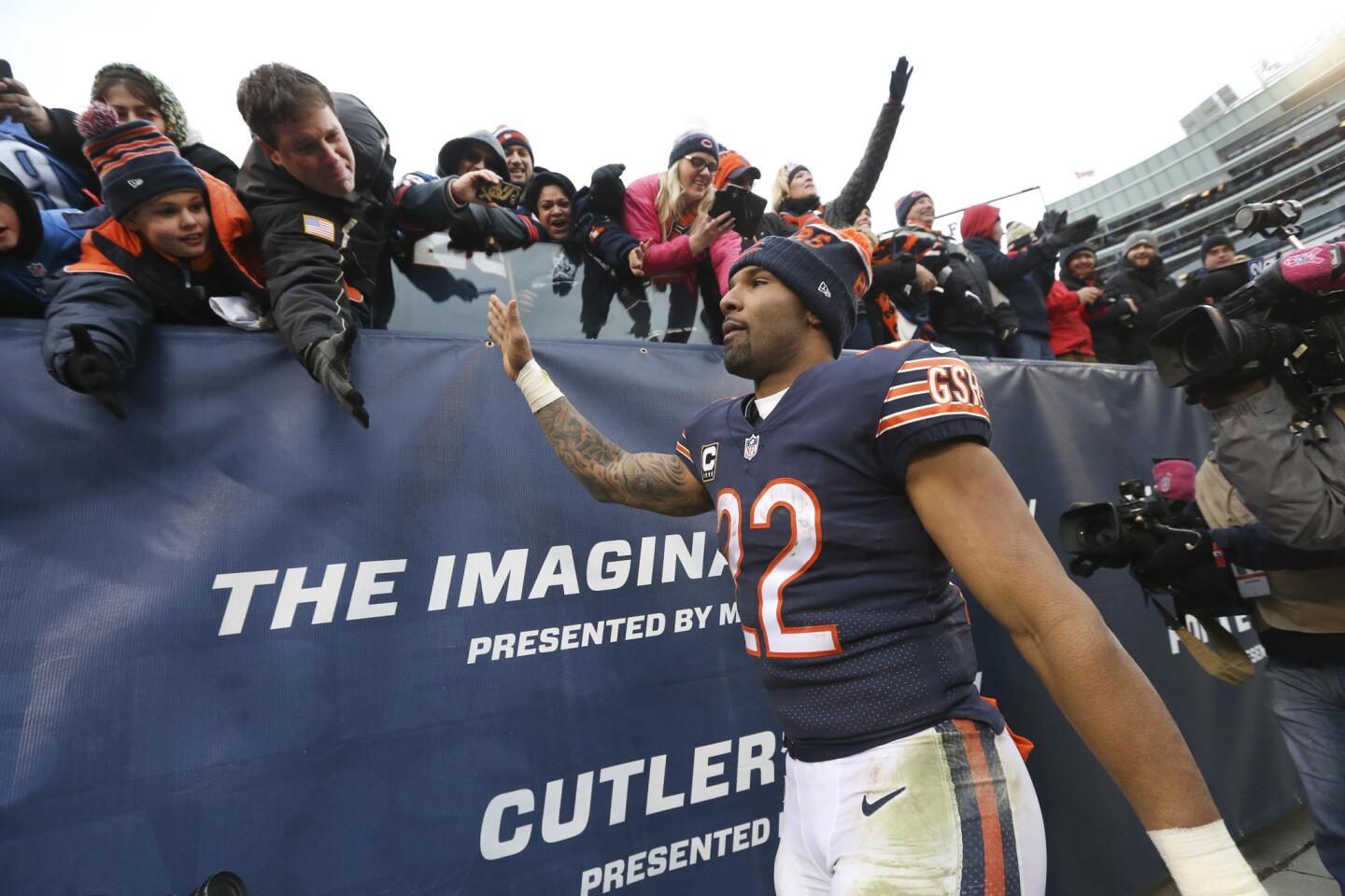 Matt Forte high-fives fans before walking off the field following his team's 24-20 loss to the Lions at Soldier Field.