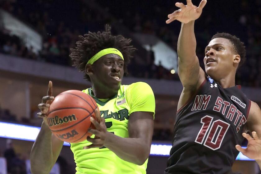 Baylor forward Johnathan Motley tries to power his way to the basket against New Mexico State's Jemerrio Jones during the second half of their first-round NCAA tournament game Friday.