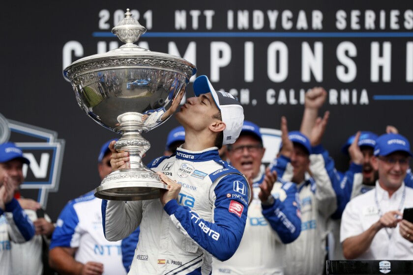 NTT IndyCar Series winner Alex Palou, center, celebrates with the tro