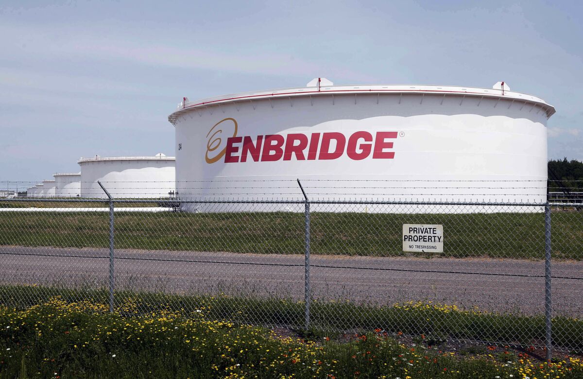 FILE - This June 29, 2018 file photo shows tanks at the Enbridge Energy terminal in Superior, Wis. The state of Minnesota has gone to federal court to block a lawsuit over Enbridge Energy's Line 3 oil pipeline project from proceeding in tribal court. The novel case names Manoomin — the Ojibwe word for wild rice — as the lead plaintiff. Wild rice is sacred in Ojibwe culture and a traditional source of food. The lawsuit, which was filed two weeks ago in the White Earth Band's tribal court, is the first "rights of nature" enforcement case brought in a U.S. tribal court and the second such case to be filed in any U.S. court. (AP Photo/Jim Mone, File)