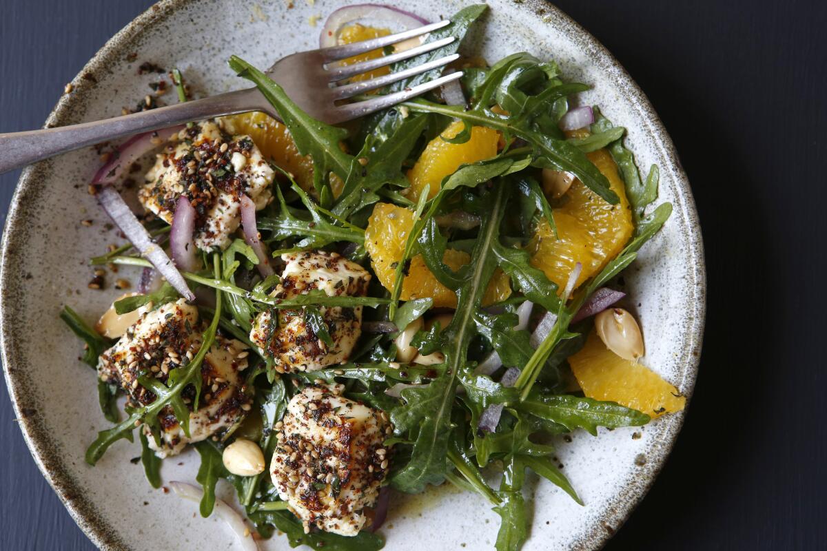 This wild arugula and orange salad includes baked feta, honey and za'atar.