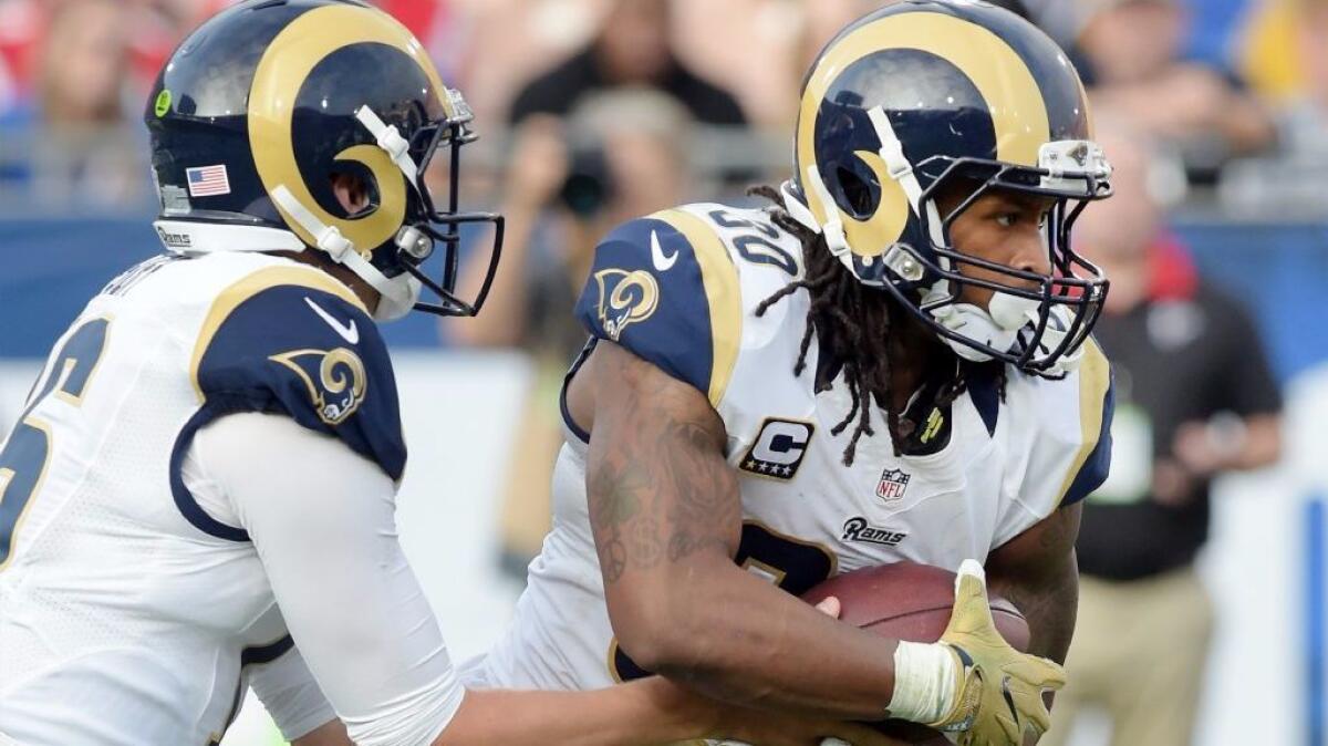 Rams running back Todd Gurly takes a handoff from quarterback Jared Goff during the third quarter of a game against the Falcons on Dec. 11.