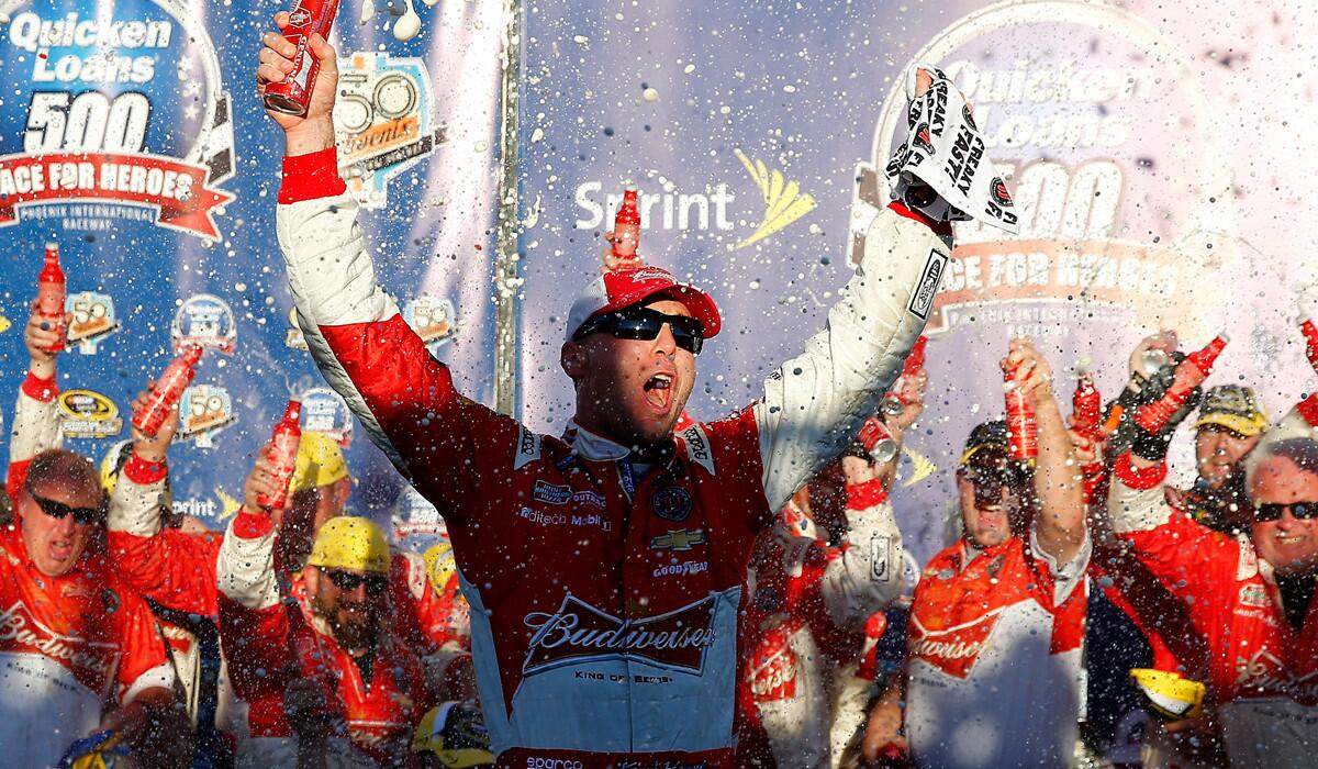 NASCAR driver Kevin Harvick and his Budweiser Chevrolet team celebrate in Victory Lane after winning the Sprint Cup Series race at Phoenix International Raceway on Sunday.