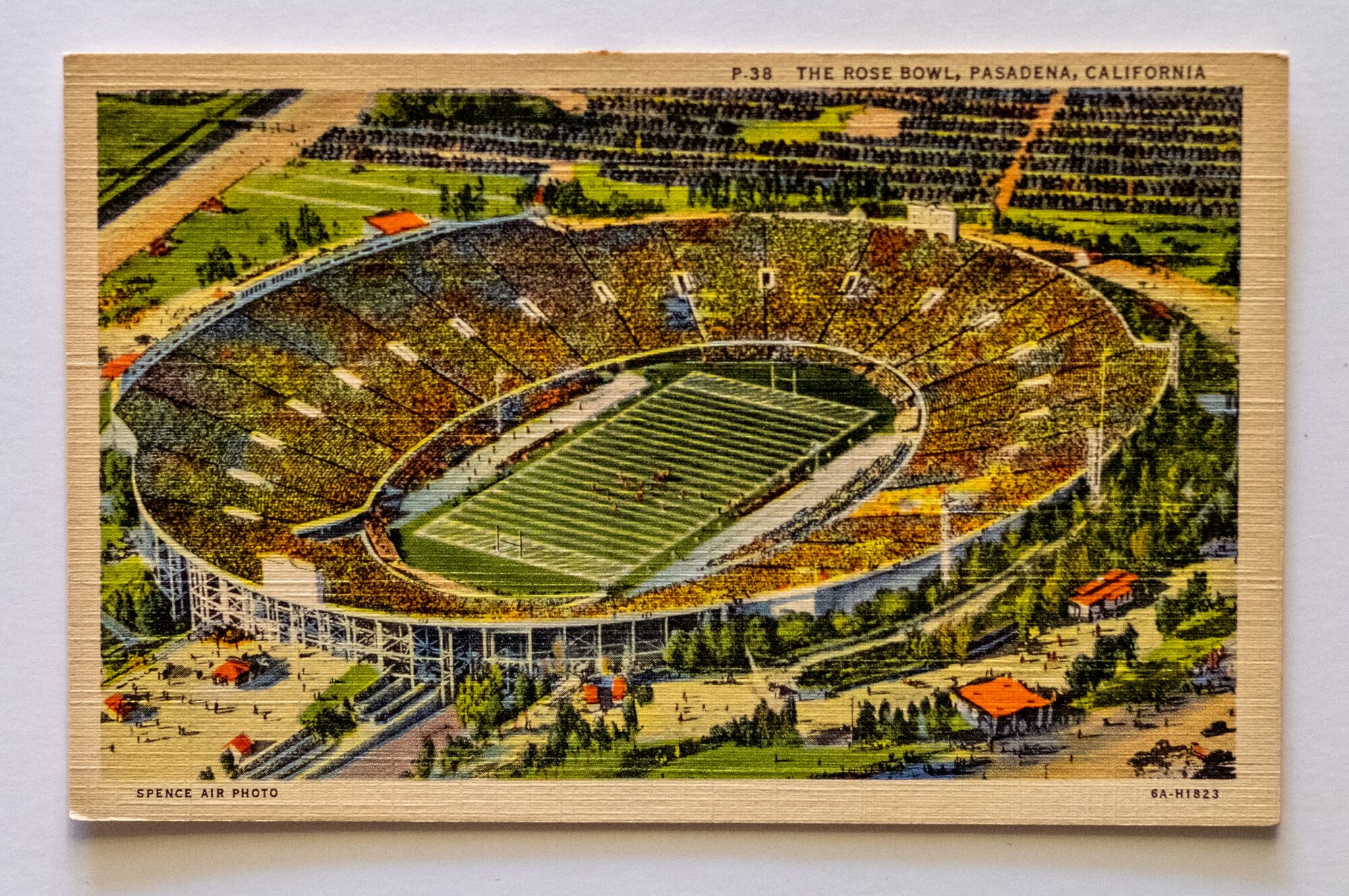 A postcard featuring a colorized sketch of the Rose Bowl