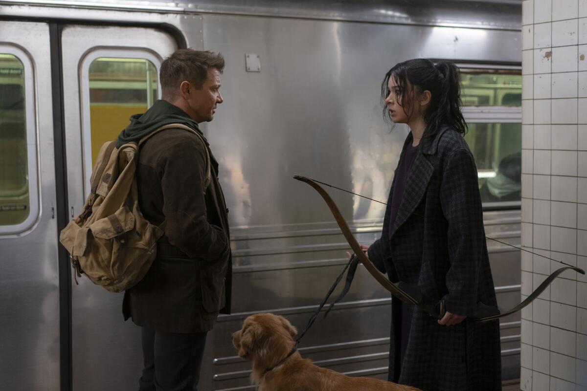 Jeremy Renner and Hailee Steinfeld with a dog on "Hawkeye"