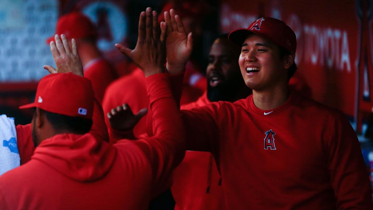 The Angels' Shohei Ohtani and teammates get ready in the dugout before a game against the Brewers on April 10.