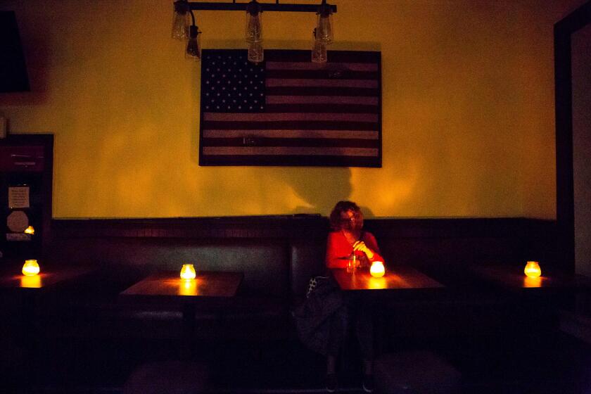 Judy Aquiline, a Sonoma local, sits in the candle-lit restaurant Reel and Brand in Sonoma, California, on October 9, 2019, during a planned power outage by the Pacific Gas & Electric (PG&E) utility company. - Rolling blackouts set to affect millions of Californians began on October 9 as a utility company started switching off power to an unprecedented number of households in the face of hot, windy weather that raises the risk of wildfires. (Photo by Brittany Hosea-Small / AFP) (Photo by BRITTANY HOSEA-SMALL/AFP via Getty Images) ** OUTS - ELSENT, FPG, CM - OUTS * NM, PH, VA if sourced by CT, LA or MoD **