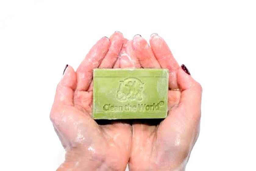 A woman holds a bar of Clean the World's recycled soap. The charitable organization distributes its soap to scores of countries across the globe. (Clean the World)