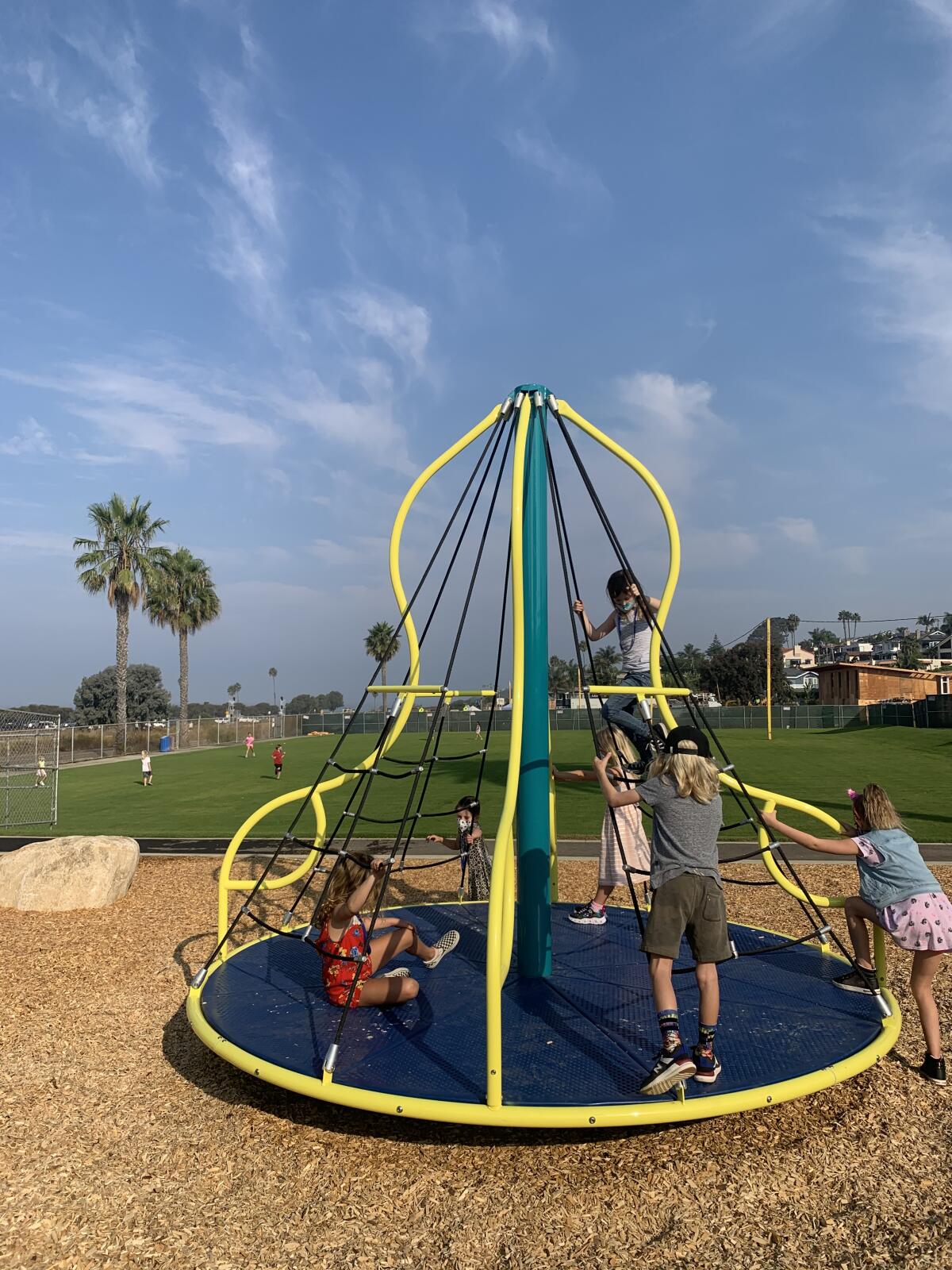 Cardiff School students play on the new playground equipment on campus.