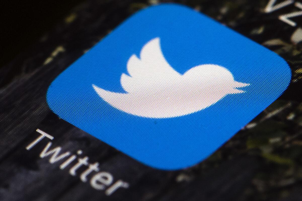 FILE- The Twitter icon is displayed on a mobile phone in Philadelphia on April 26, 2017. Twitter said in a statement Friday, April 15, 2022, that its board of directors has unanimously adopted a “poison pill” defense in response to Tesla CEO Elon Musk’s proposal to buy the company and take it private. (AP Photo/Matt Rourke, File)