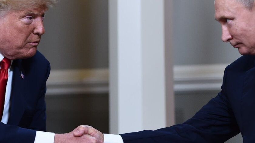 President Trump and Russian leader Vladimir Putin shake hands ahead of a private meeting in Helsinki, Finland, on July 16, 2018.