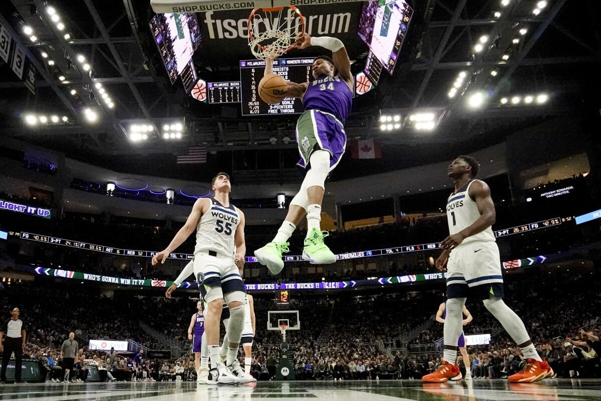 Giannis Antetokounmpo, de los Bucks de Milwaukee, retaca el balón ante las mirada de Luka Garza