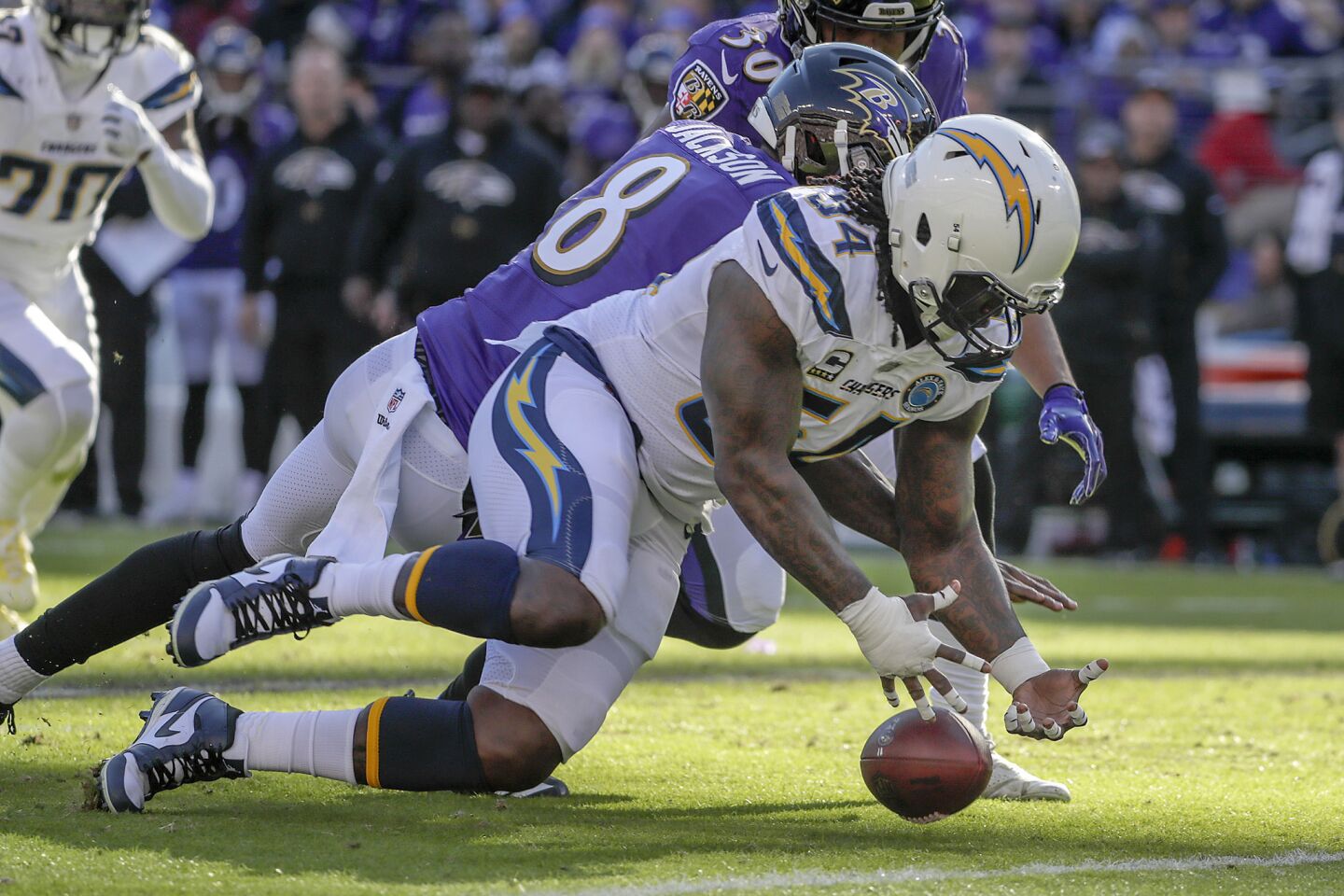 Chargers linebacker Melvin Ingram chases after a fumble by Ravens quarterback Lamar Jackson, who ultimately recovered it during the first half.