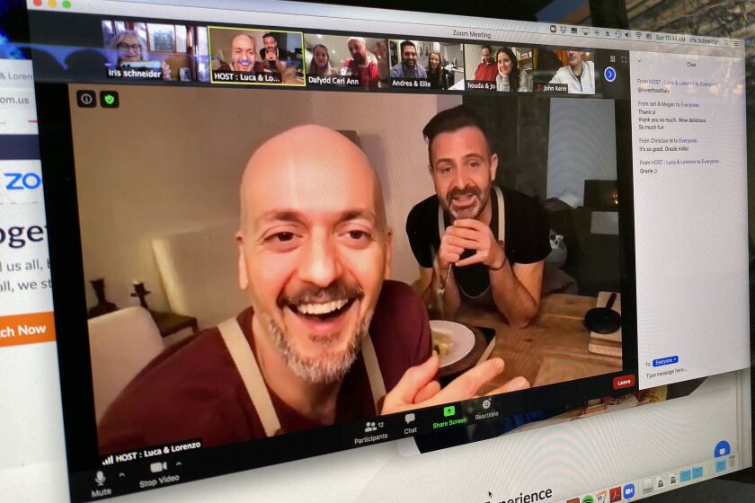Cooking via Zoom. February 14, 2021. Italian chefs Luca Brozzi, left, and Lorenzo Manfrini talk to their students while teaching a ravioli-making class via Zoom from their home near Florence, Italy.