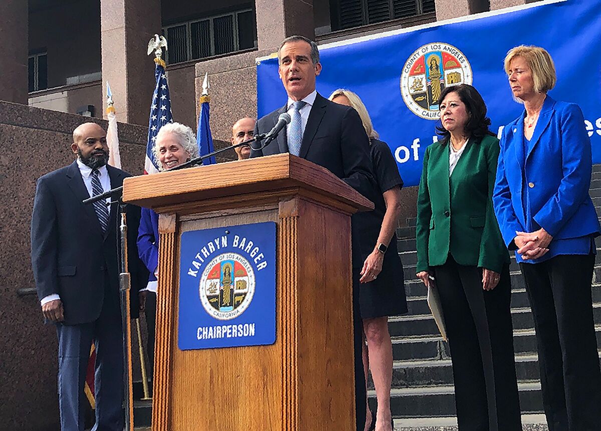 Los Angeles Mayor Eric Garcetti speaks at a news conference that announced that six new cases of the coronavirus have been confirmed in Los Angeles County, where there was one previously, on the steps of the county Hall of Administration in downtown Los Angeles Wednesday, March 4, 2020 The cases confirmed Tuesday night were due to a known exposure and not the result of so-called community transmission, Dr. Barbara Ferrer, director of the county Department of Public Health, said. One person was hospitalized and five others were in self-quarantine at home, she said. The cases were from throughout the county, she said, but did not give specific locations. (AP Photo/Stafanie Dazio)