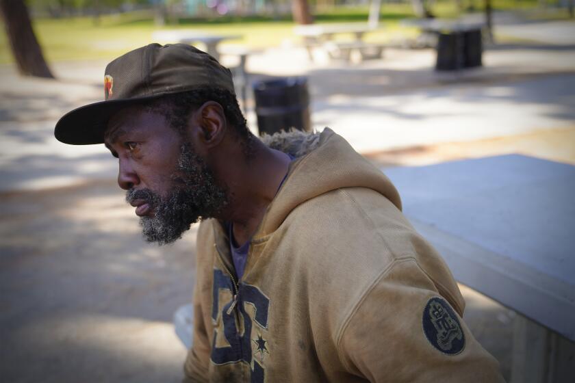 El Cajon, CA - May 18: Matthew Clark, 55 relaxes at a park bench Wells Park on Wednesday, May 18, 2022 in El Cajon, CA. Clark says he has been living on the streets between el Cajon and downtown San Diego for the past 4-years . (Nelvin C. Cepeda / The San Diego Union-Tribune)