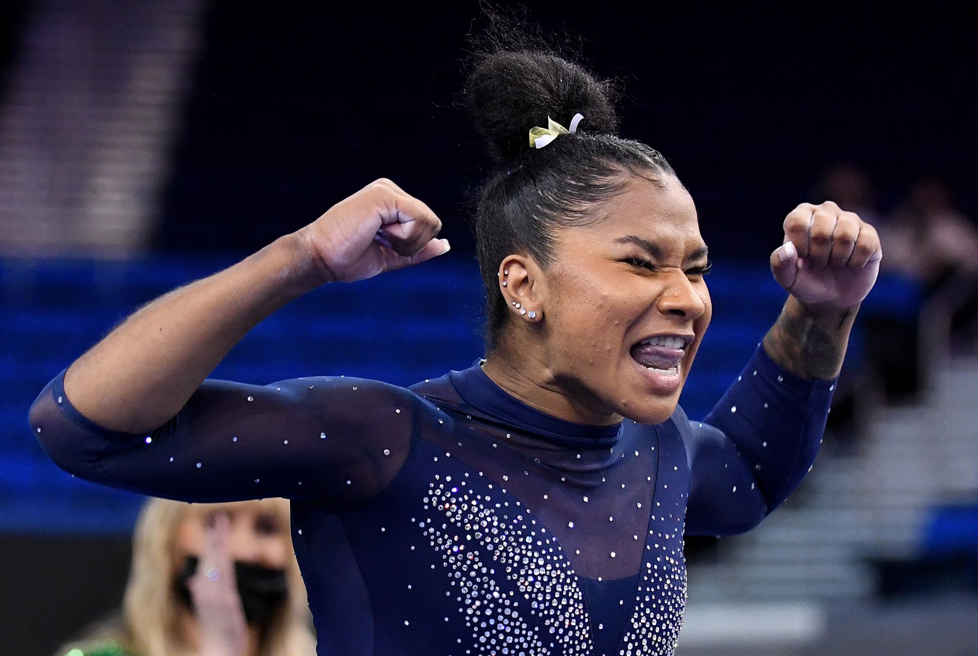 UCLA's Jordan Chiles raises her fists and smiles after her routine on the balance beam.