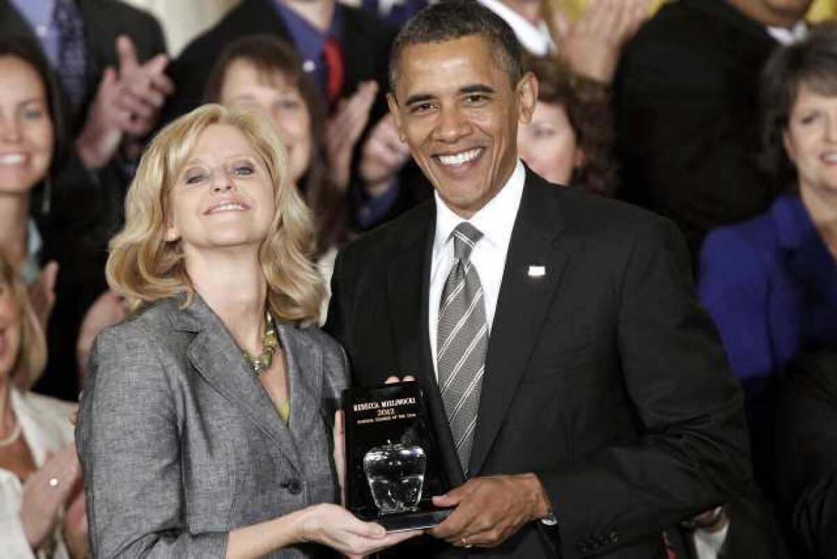 President Barack Obama presents the 2012 National Teacher of the Year award to Rebecca Mieliwocki, who teaches at Luther Burbank Middle School, on Tuesday, April 24, 2012, during a ceremony in the East Room at the White House in Washington.