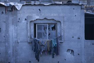 A child looks through a broken window in Rafah, Gaza Strip, Wednesday, Feb. 21, 2024. An estimated 1.5 million Palestinians displaced by the war took refuge in Rafahor, which is likely Israel's next focus in its war against Hamas. (AP Photo/Fatima Shbair)