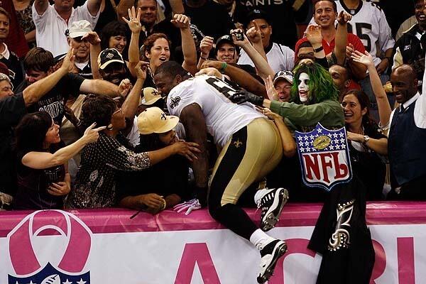 Anthony Hargrove #69 of the New Orleans Saints jumps into the crowd after defeating the New York Jets 24-10 at the Louisana Superdome in New Orleans, Louisiana.