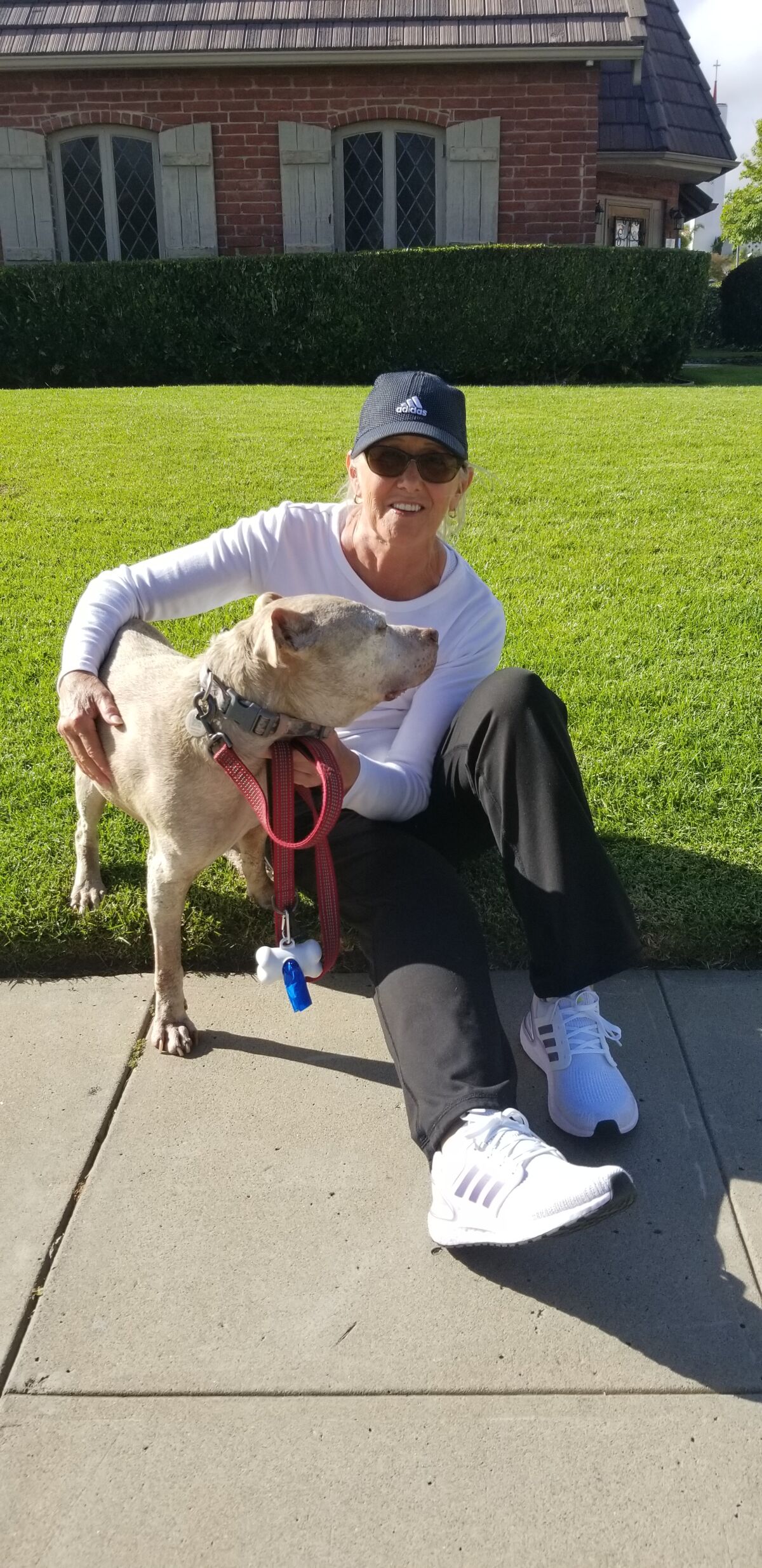 Patricia Robles and her dog Minnie pause during a walk along Diamond Street.