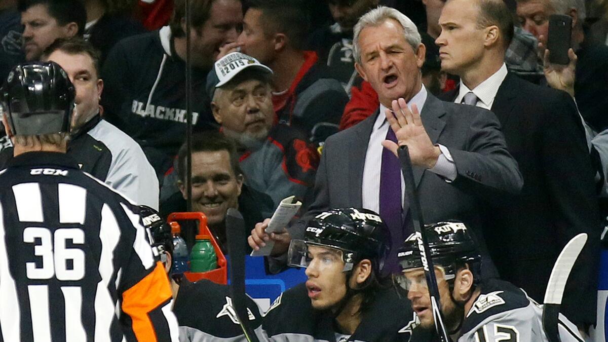 Coach Darryl Sutter talks with referee Dean Morton after the Kings had a goal disallowed.