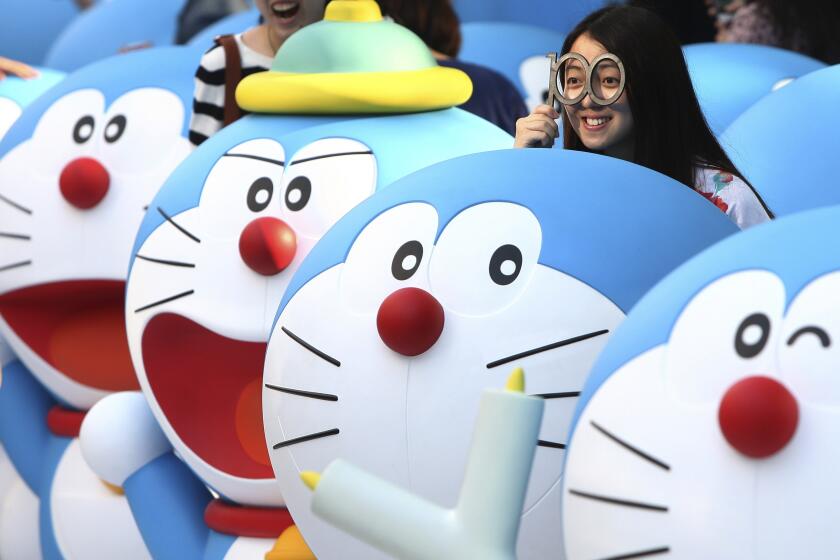 FILE - Models of Doraemon, one of Japan's most popular manga and anime characters, are displayed in Shanghai on April 28, 2013. (AP Photo/File)