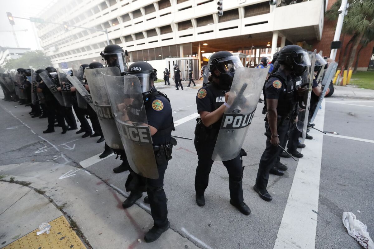 Police in Miami stand in formation during a protest on May 30.