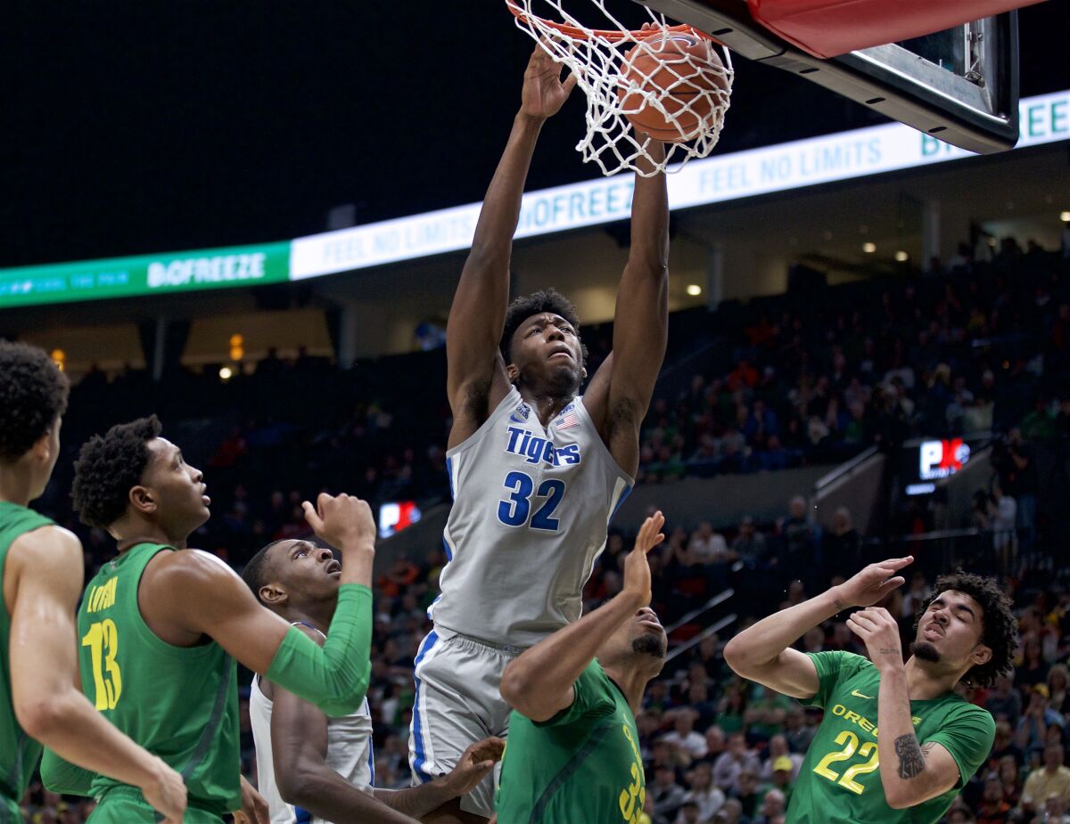 FILE - Memphis center James Wiseman (32) dunks against Oregon during the second half of an NCAA college basketball game in Portland, Ore., in this Tuesday, Nov. 12, 2019, file photo. At long last, James Wiseman is about to be on a team again. More than a year removed from the end of his three-game college career that was doomed almost before it started because of NCAA rulings regarding his eligibility, the 7-foot-1 left-hander will be one of the first players selected in Wednesday’s, Nov. 18, 2020, NBA draft. It’s hard to envision a scenario where he doesn’t go in the first three picks, which are currently held by Minnesota, Golden State and Charlotte.(AP Photo/Craig Mitchelldyer, File)