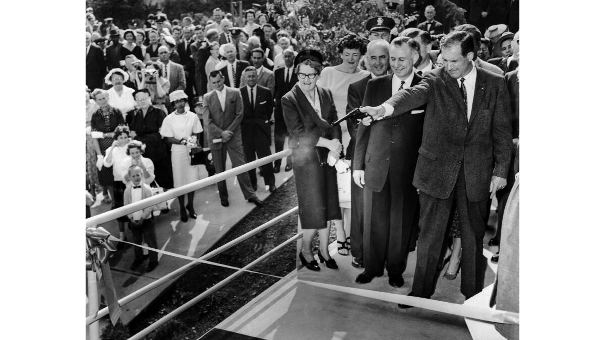 April 8, 1960: Los Angeles County Sheriff Peter J. Pitchess cuts the ribbon with a bullet at the opening of a new pistol range at the Sheriff's Academy.