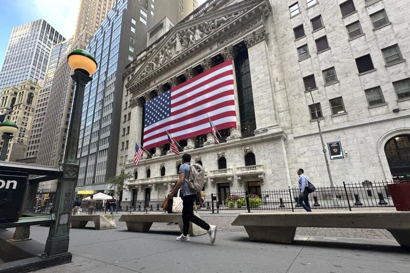 FILE - American flags hang on the front of the New York Stock Exchange on Sept. 11, 2024, in New York. (AP Photo/Peter Morgan, File)