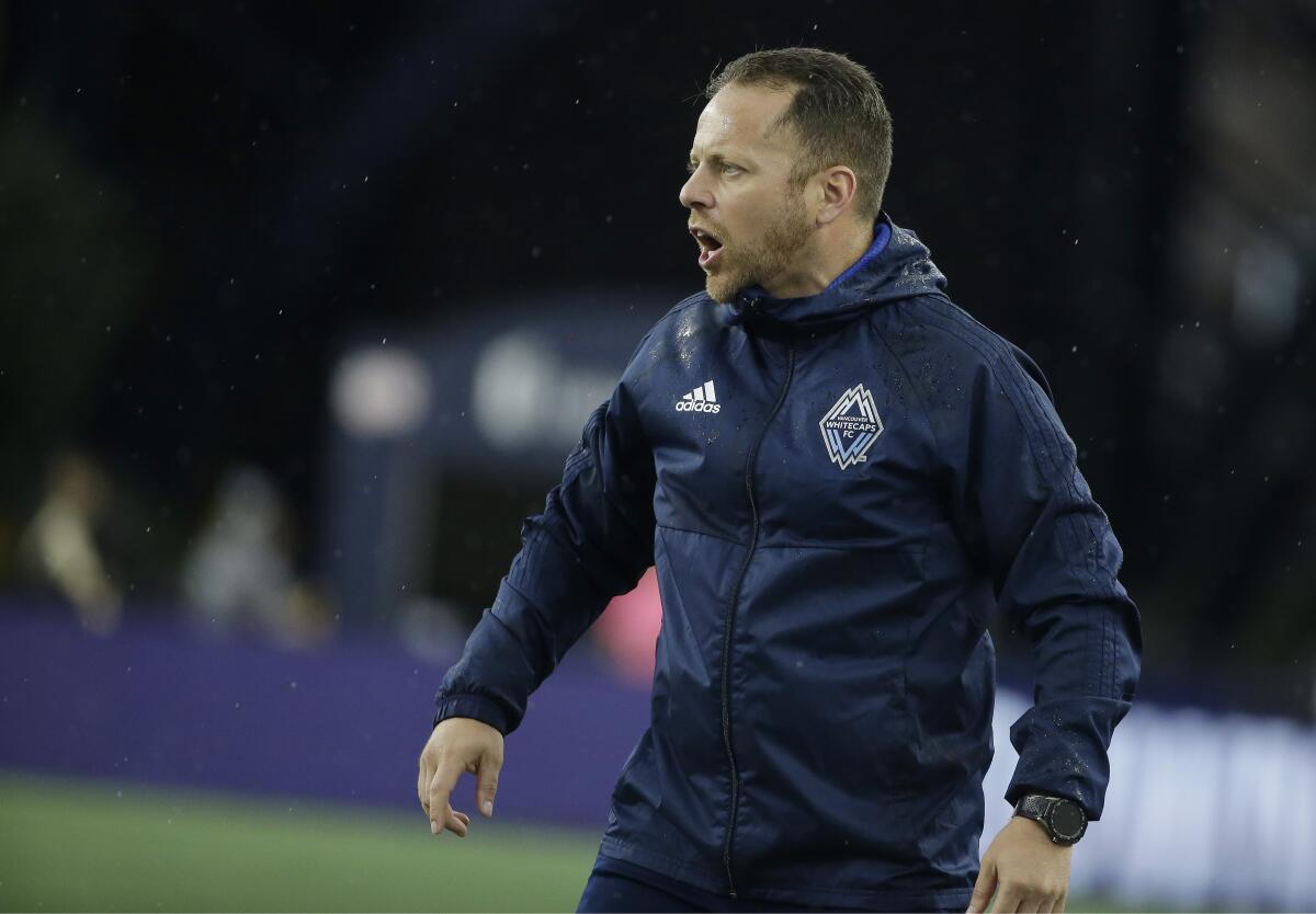 Vancouver Whitecaps coach Marc Dos Santos gives direction to his players.