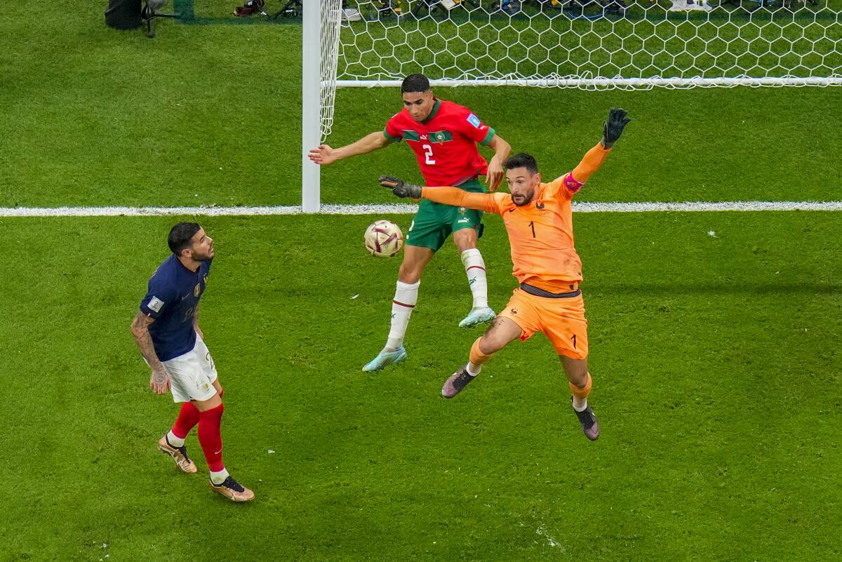 France goalkeeper Hugo Lloris, right, battles for the ball during a World Cup semifinal match.