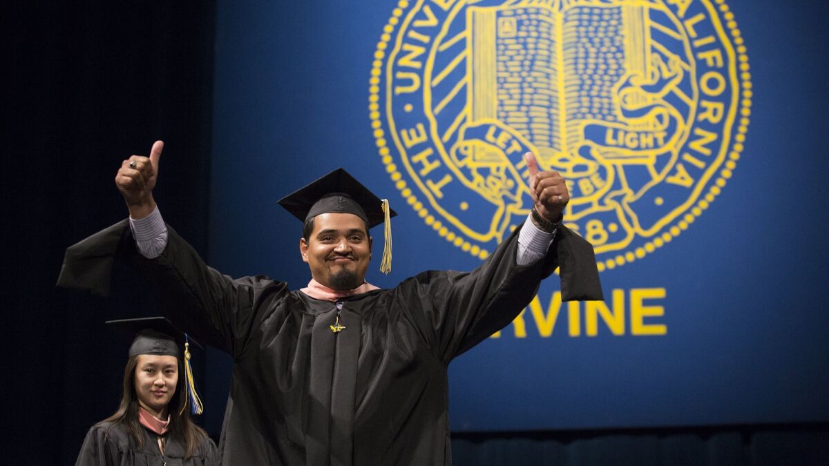 Ivan Delgadillo celebrates during the 2017 commencement ceremony for the School of Social Ecology at UC Irvine on June 16.