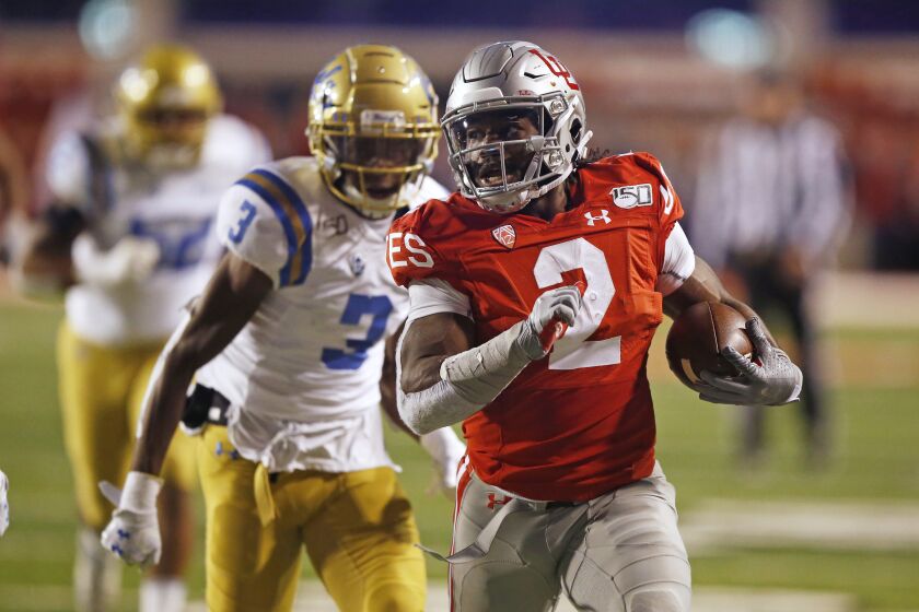 Utah running back Zack Moss (2) leaves UCLA defensive back Rayshad Williams (3) behind on his way to a touchdown during the first half of an NCAA college football game Saturday, Nov. 16, 2019, in Salt Lake City. (AP Photo/Rick Bowmer)