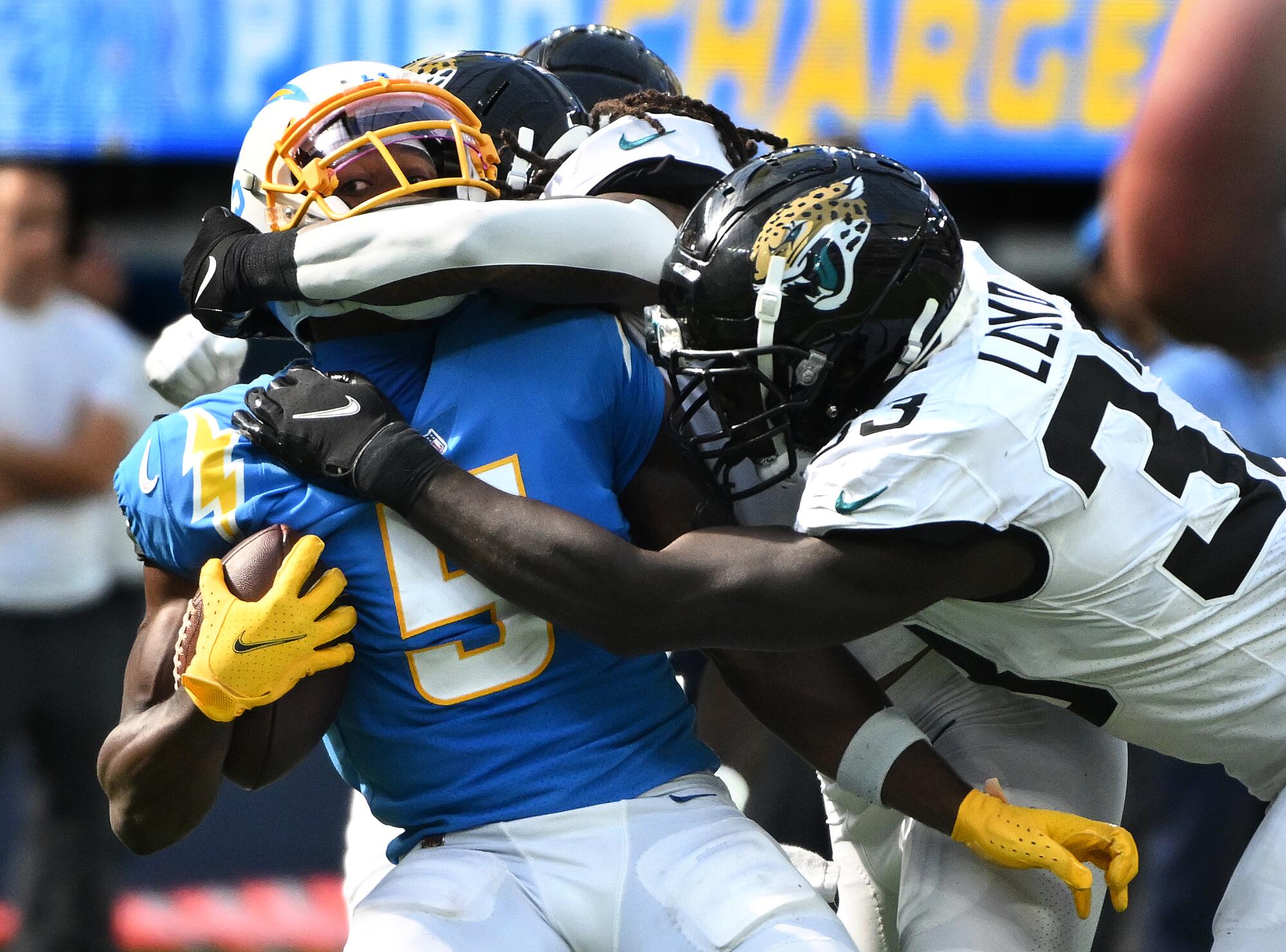 Chargers receiver Joshua Palmer is taken down.