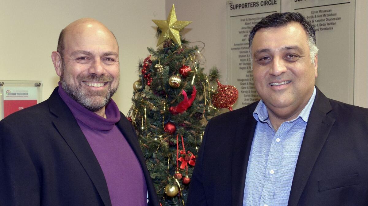 Garen Yegparian, who co-founded the local chapter of the ANCA, left, enjoying Monday's celebration with Burbank Police Commissioner Hagop Hergelian.