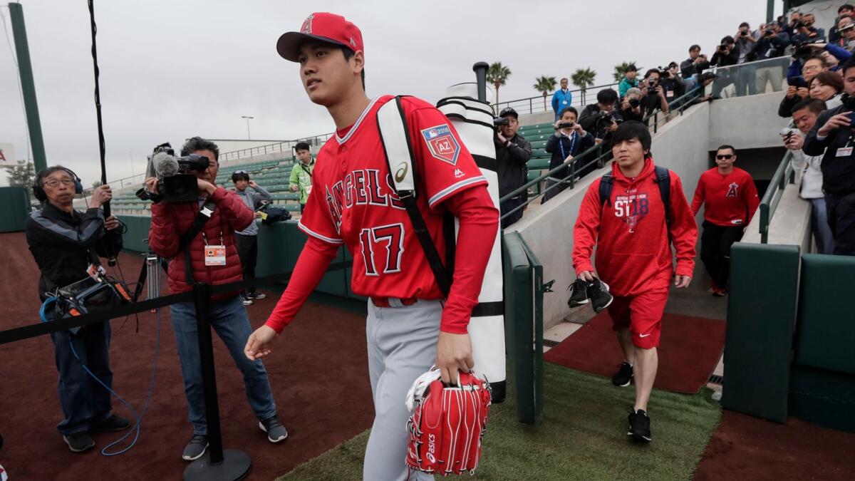 Shohei Ohtani experiences his first day of spring training camp along with other pitchers and catchers at Tempe Diablo Stadium on Feb. 14.