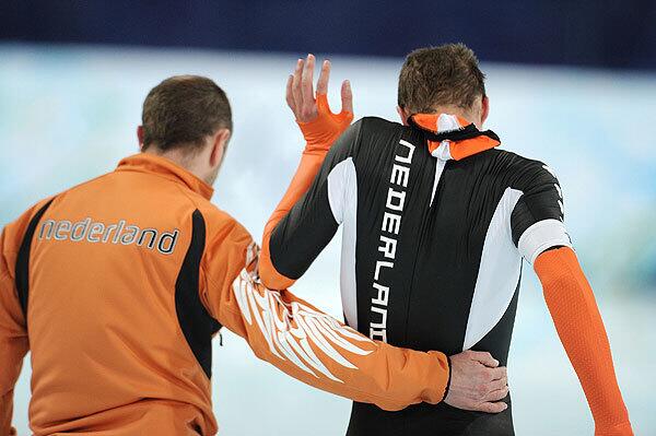 Sven Kramer of Netherlands reacts with coach Gerard Kemkers after finishing first but being disqualified in the men's speed skating 10000m. Kemkers told Kramer to switch lanes in mid race. After the race Kramer yelled at Kemkers and threw his goggles.