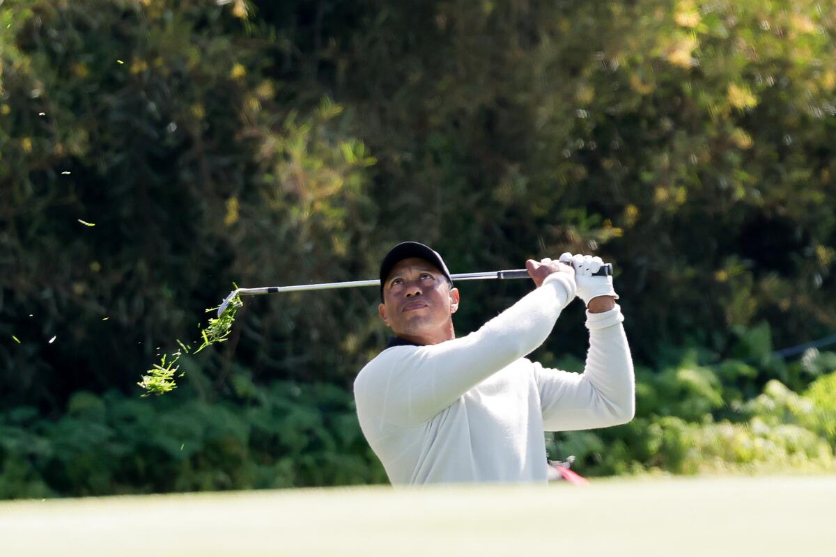 Tiger Woods watches his approach shot on the 13th hole during the first round of the Genesis Invitational on Thursday.
