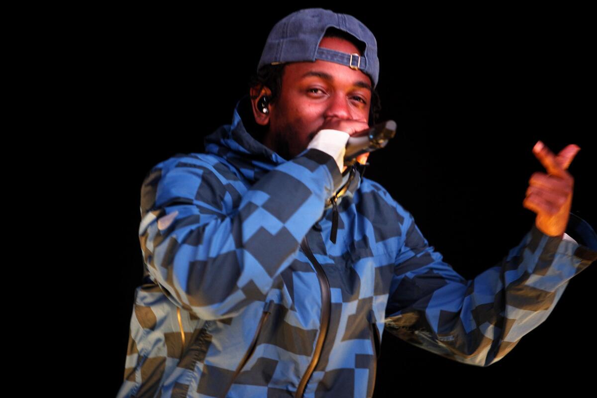 Kendrick Lamar performs during the Nike Air + Style combo concert and snowboarding event at the Rose Bowl in Pasadena in February. On Thursday, the performer mounted a traffic light pole near L.A. Live downtown to shoot his latest video for the track "Alright" from his "To Pimp a Butterfly" album.