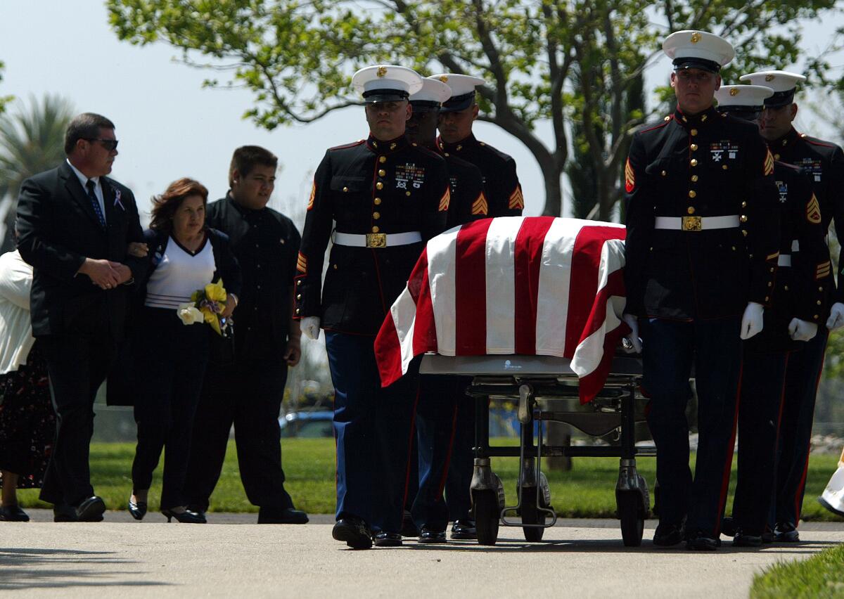 Simona Garibay follows the casket of her son, Cpl. Jose Garibay, who was killed in Iraq, at his funeral in 2003 with her other son, Gabriel, 16, at her left.