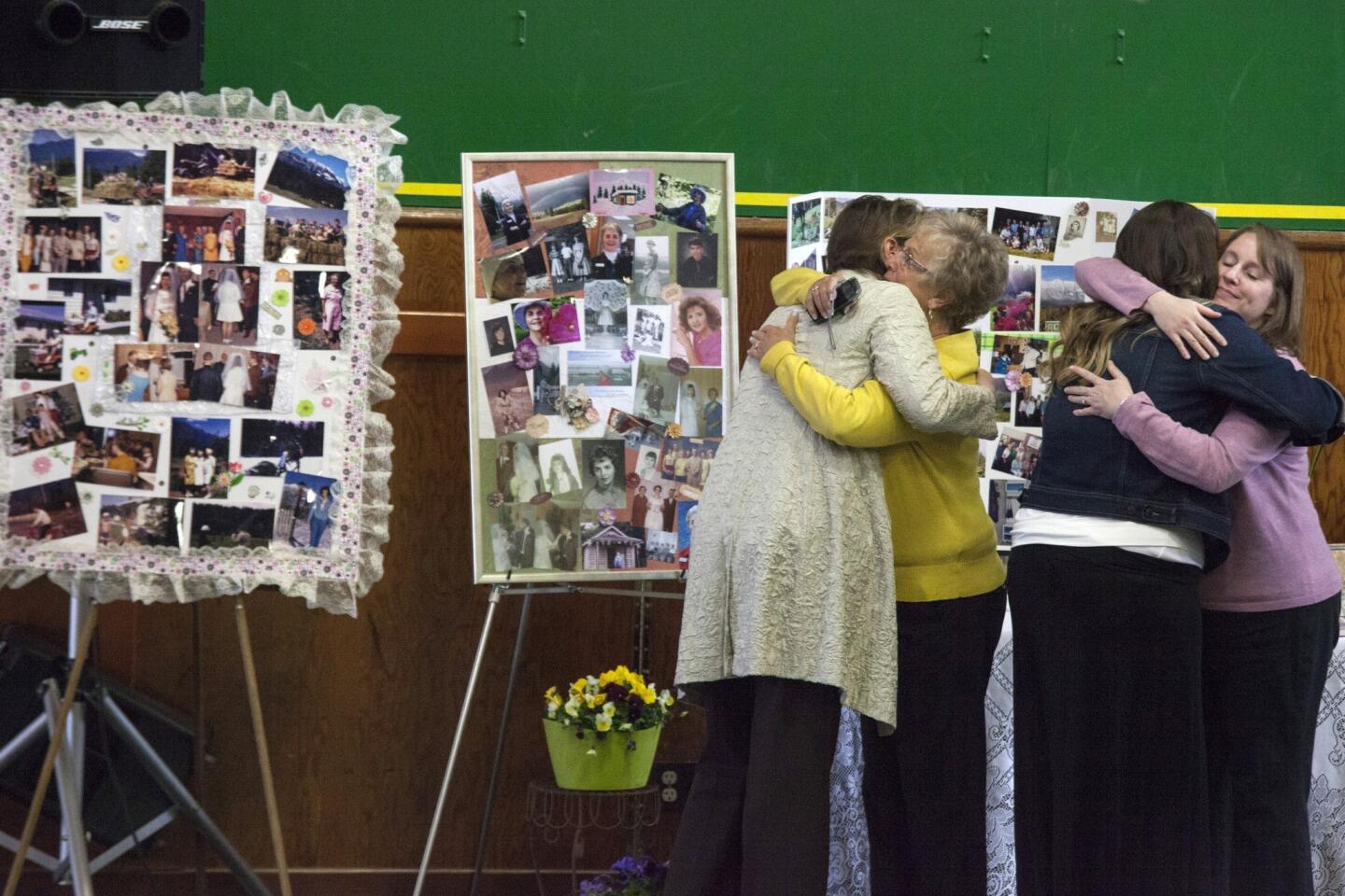 Friends embrace during a memorial service for Linda McPherson on Saturday in Darrington, Wash., April 5.