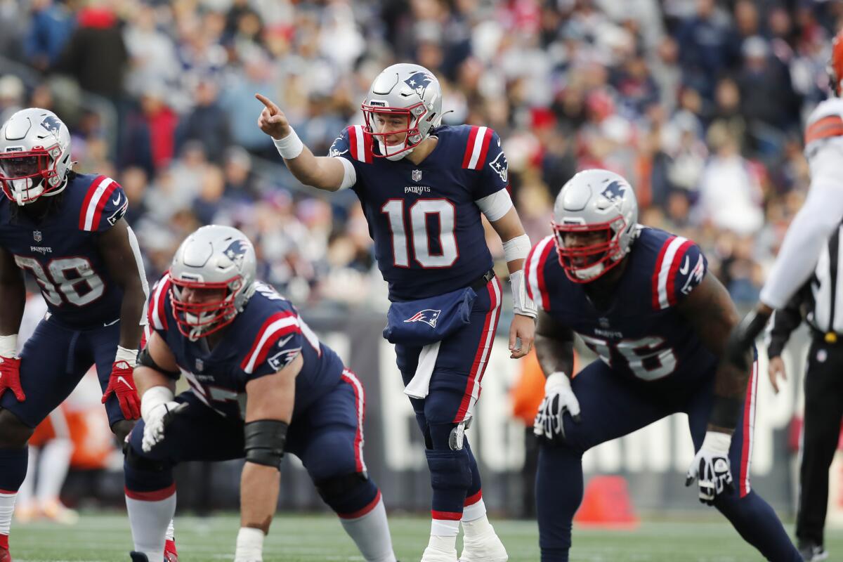 New England Patriots quarterback Mac Jones signals during the second half.