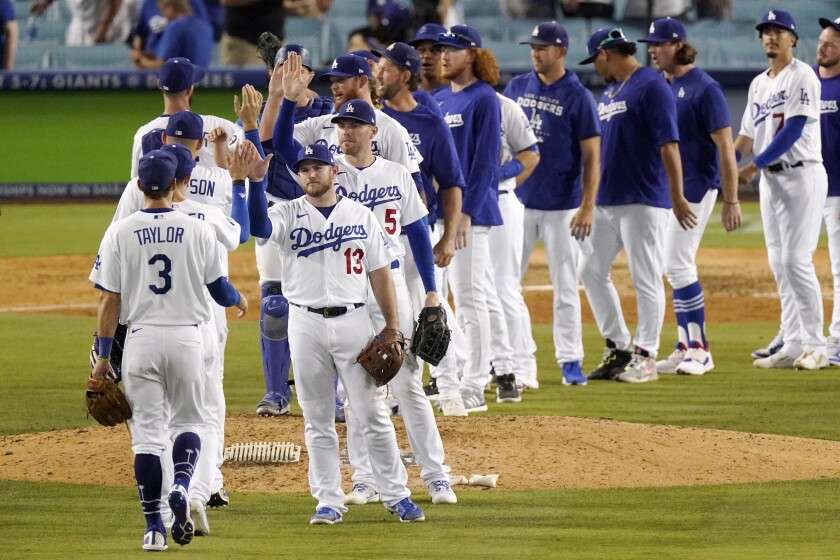 Dodgers players celebrate after defeating the Padres on Sunday.