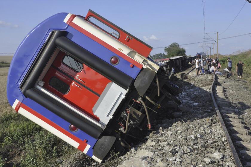 FILE - An overturned train car is seen near a village at Tekirdag province, Turkey on July 8, 2018. A court in Turkey sentenced nine rail officials to more than 108 years' imprisonment over a train crash six years ago that killed 25 people, local media reported on Thursday, April 25, 2024. A passenger train operated by Turkish State Railways, or TCDD, derailed in July 2018 as it passed through Corlu district some 110 kilometers (68 miles) west of Istanbul. (Mehmet Yirun/DHA-Depo Photos via AP)
