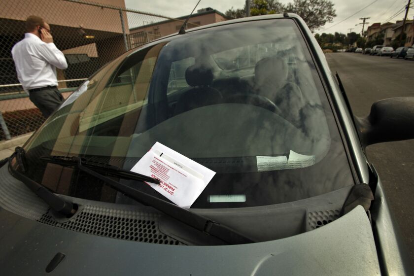 A car with a street-sweeping parking ticket; soon, technology may solve this problem.